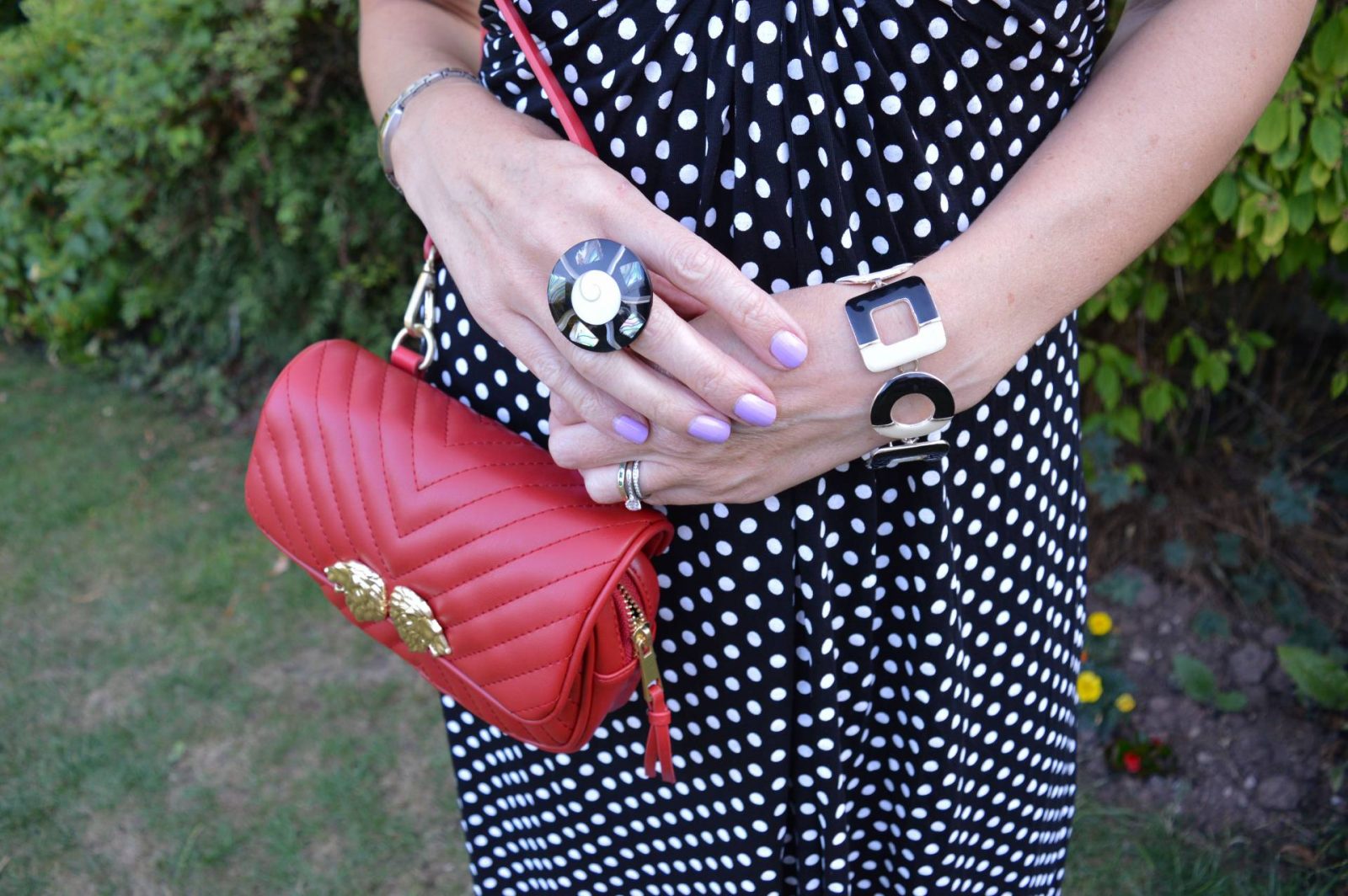 black and white polka dot dress with red accessories