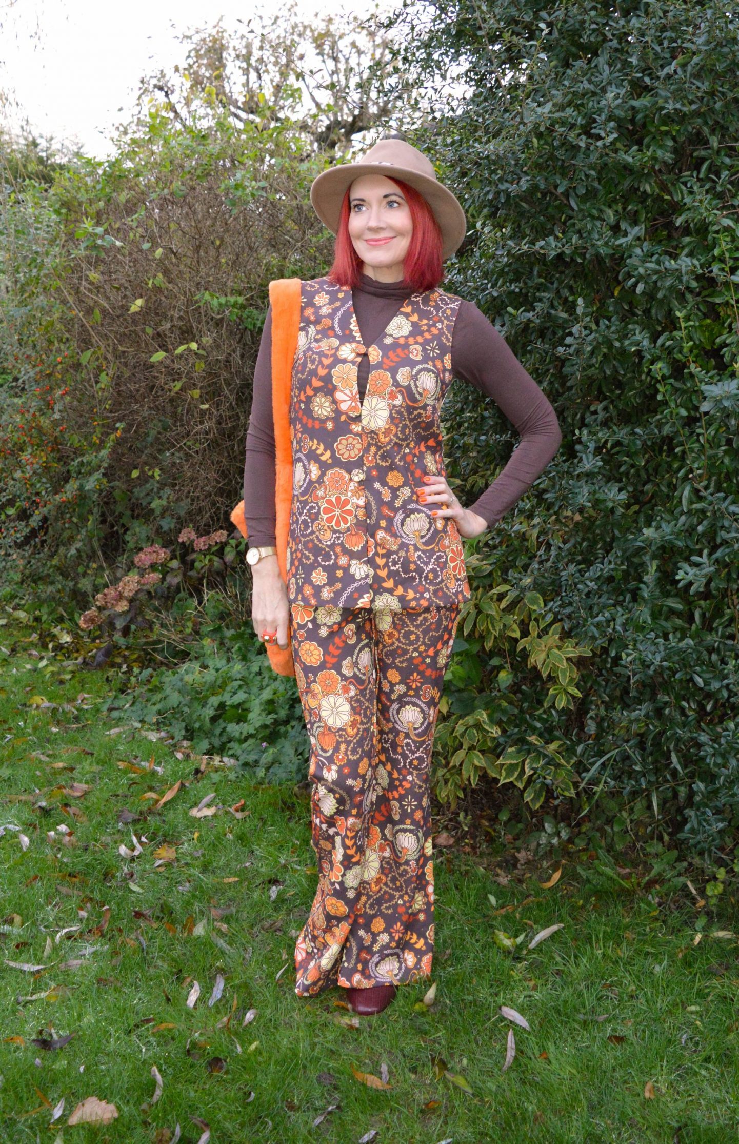 The Hippie Shake Harlow brown floral waistcoat and flares, Fenella Smith London Clemmie Orange Faux Fur Bag, Zara camel fedora